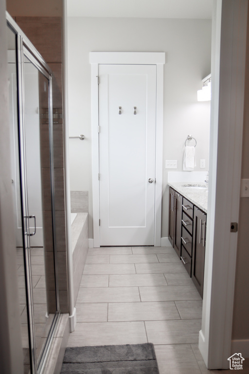 Full bath with a bath, a stall shower, and vanity