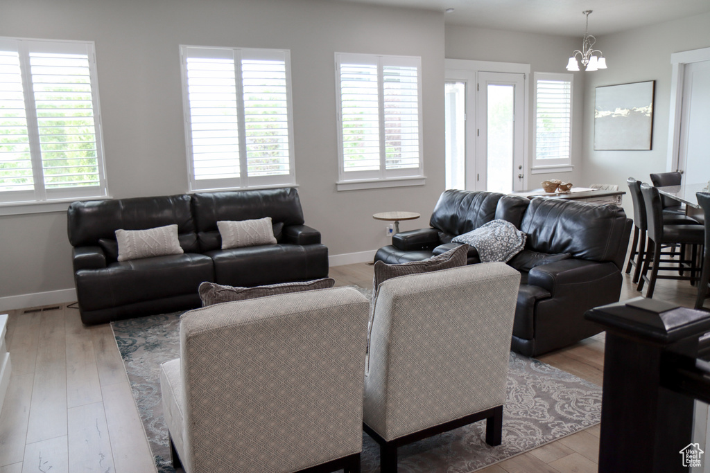 Living room featuring a chandelier and light wood finished floors