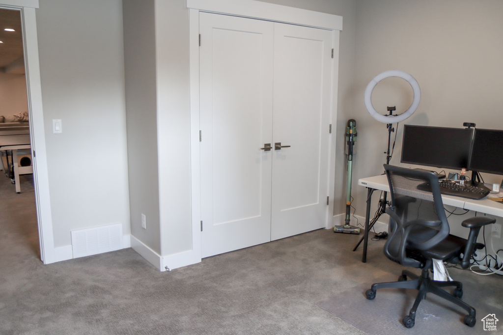 Carpeted office space featuring baseboards