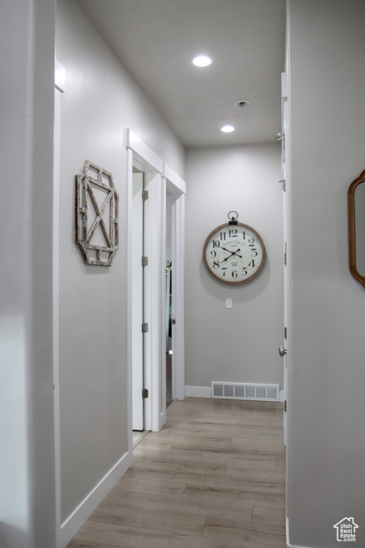 Hallway featuring recessed lighting and light wood-style flooring