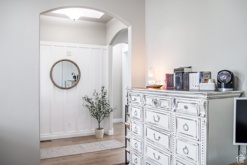 Interior space with arched walkways and wood finished floors