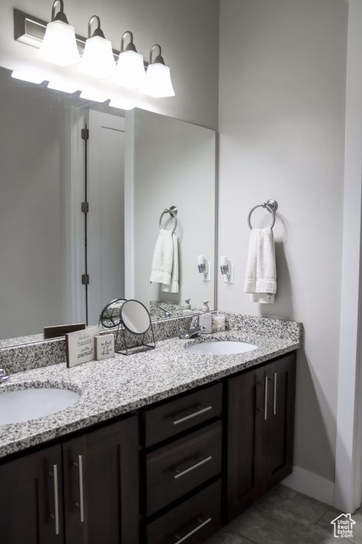 Full bath with double vanity and tile patterned flooring