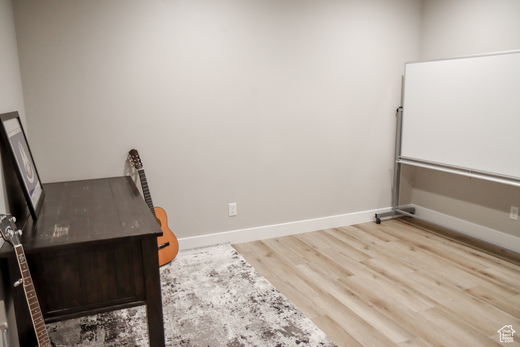 Home office featuring wood finished floors and baseboards