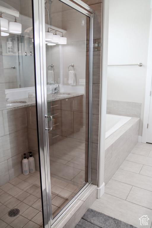 Bathroom with a shower stall, a garden tub, and tile patterned floors