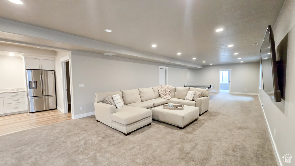 Living room with light colored carpet and recessed lighting