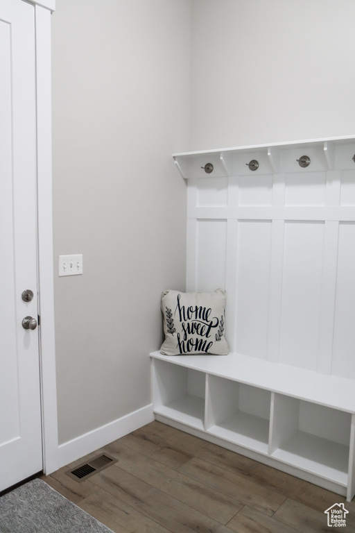 Mudroom featuring wood finished floors and baseboards