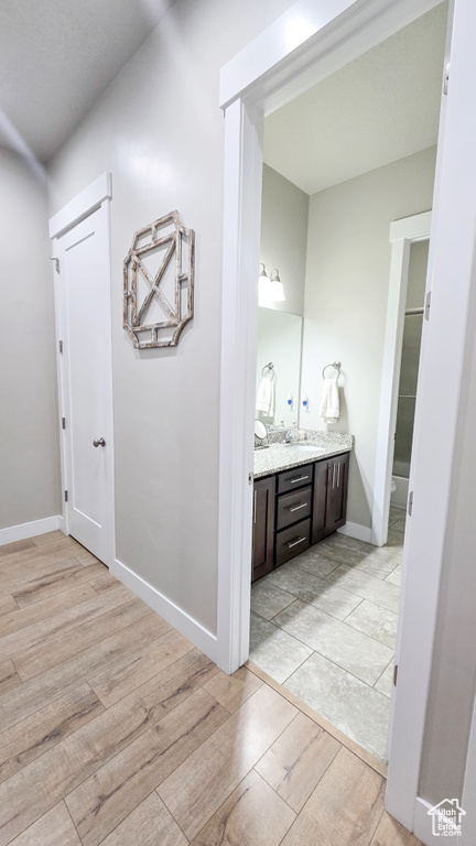 Bathroom with vanity and wood finished floors
