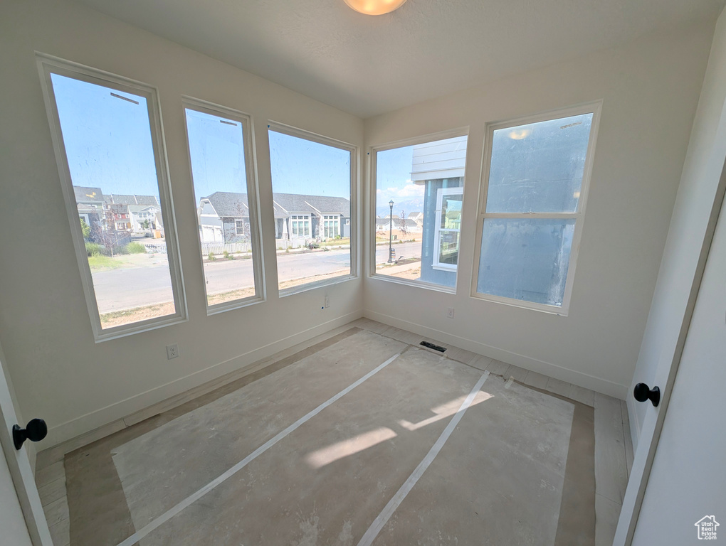 Unfurnished sunroom featuring healthy amount of natural light