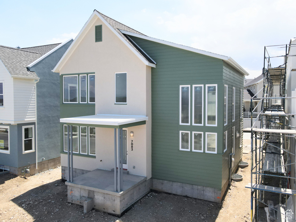 Rear view of property featuring stucco siding