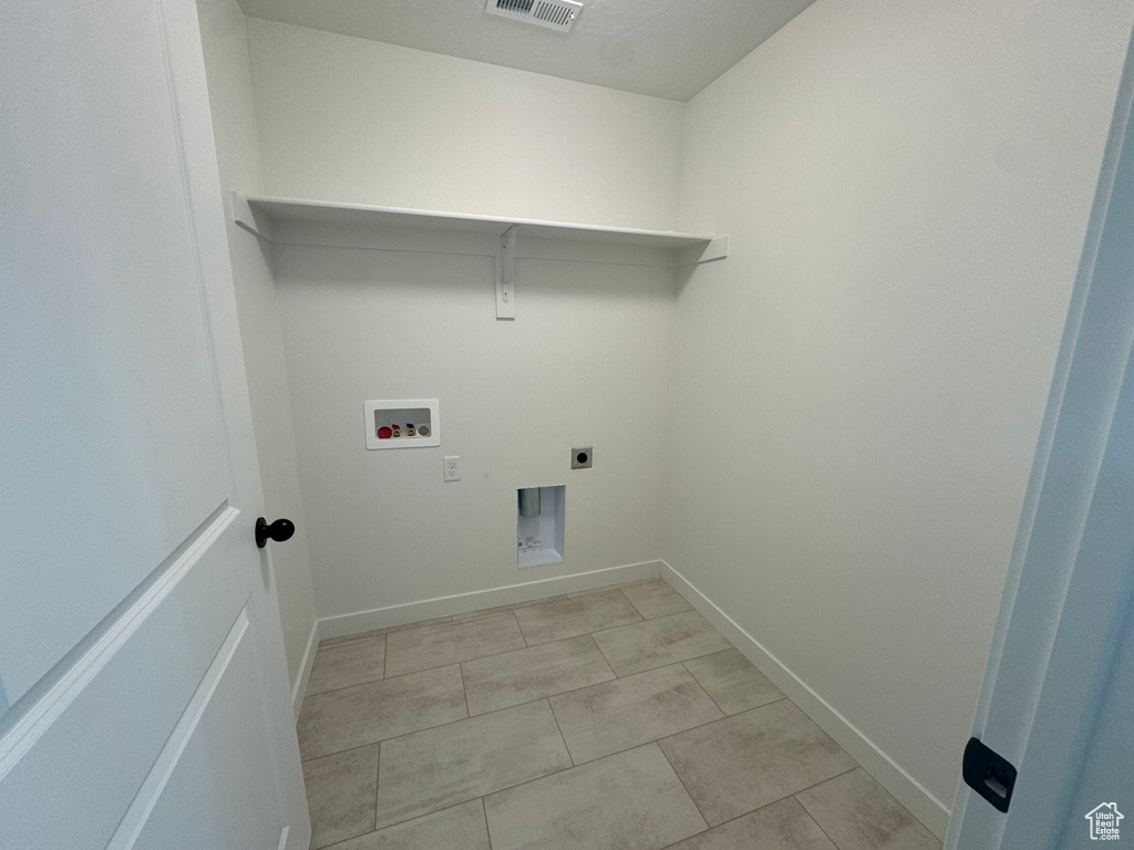 Laundry room with washer hookup, hookup for an electric dryer, and light tile patterned flooring