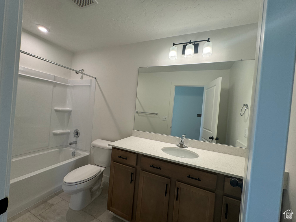 Bathroom with vanity, tile patterned floors, and shower / tub combination