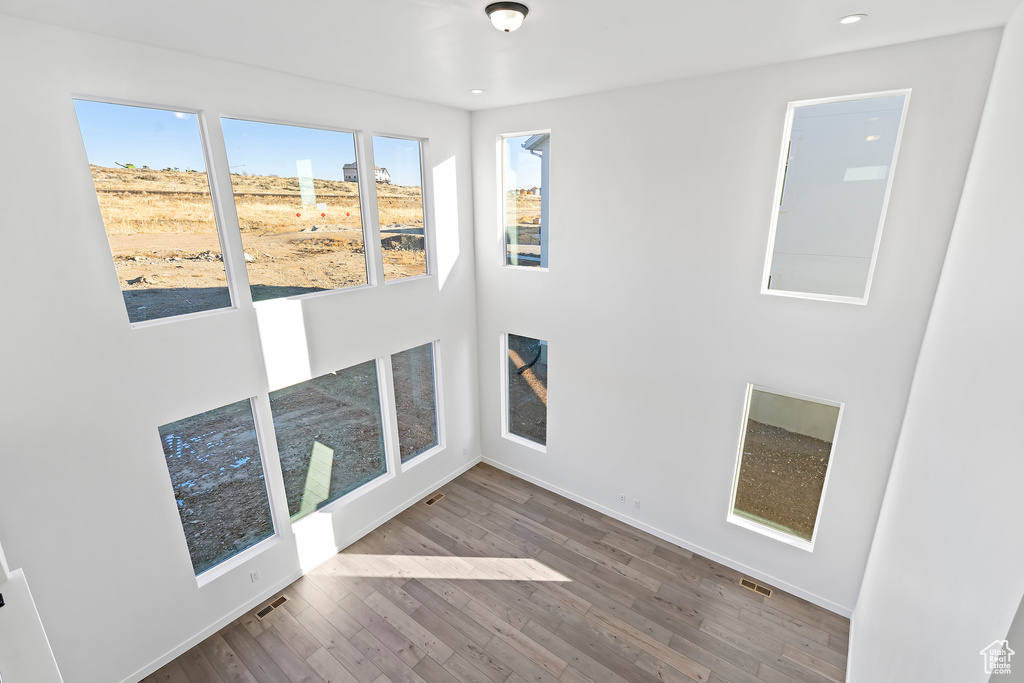 Spare room with wood finished floors and recessed lighting