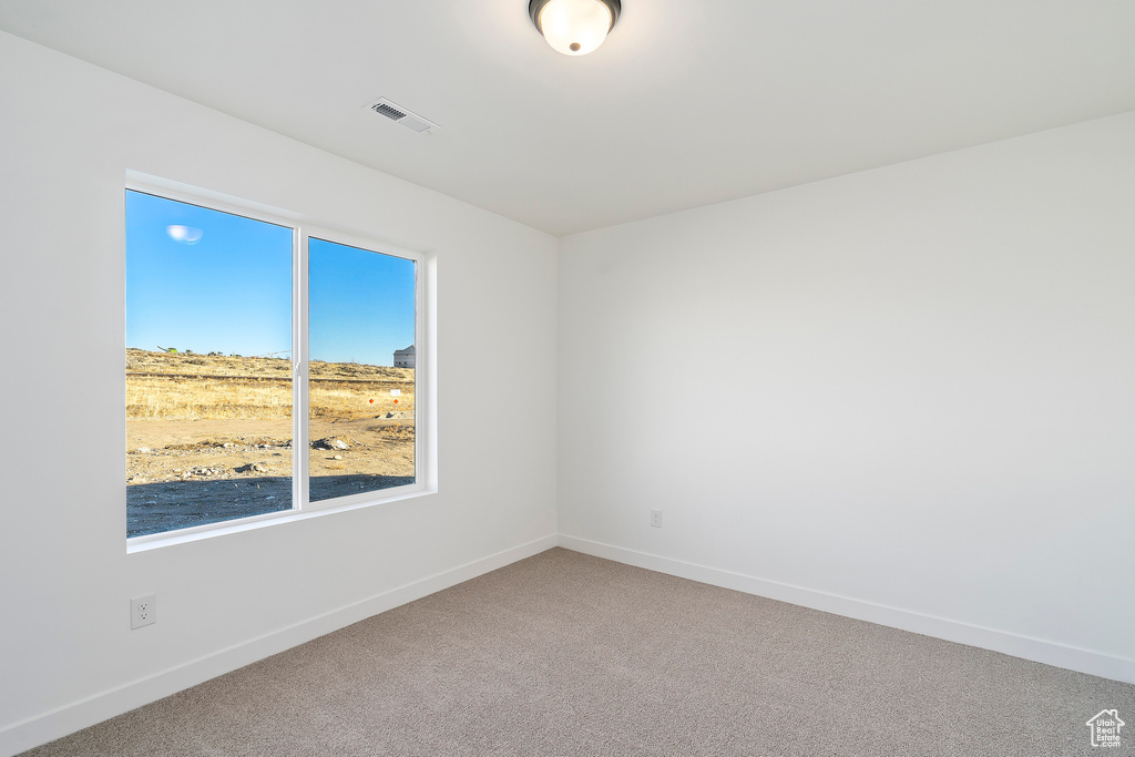 Unfurnished room with carpet floors and baseboards