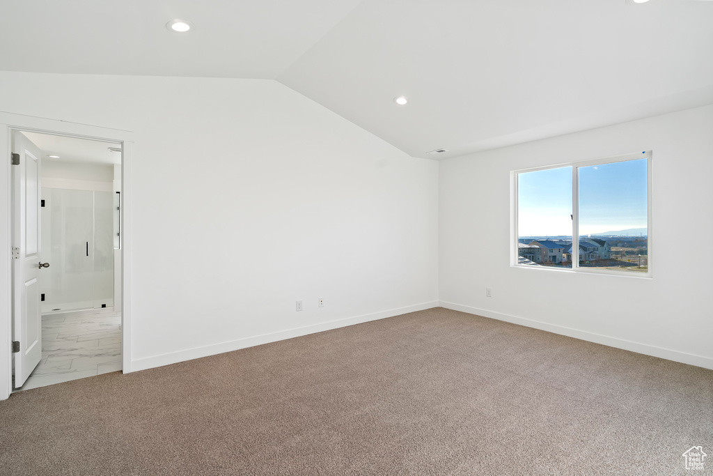 Carpeted spare room with recessed lighting and lofted ceiling