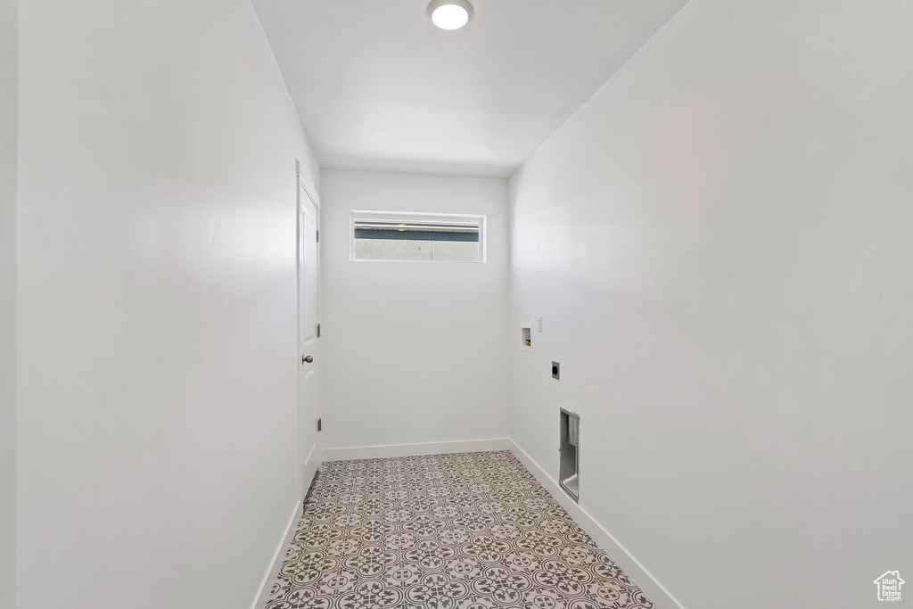 Laundry room featuring hookup for an electric dryer, hookup for a washing machine, and light floors