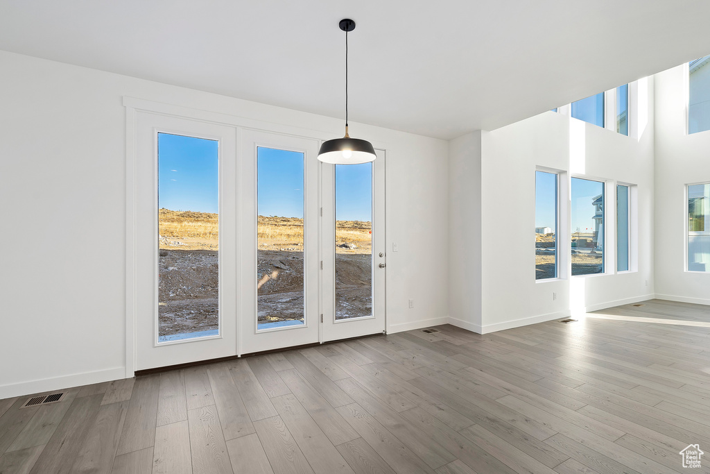 Unfurnished dining area featuring wood finished floors and baseboards