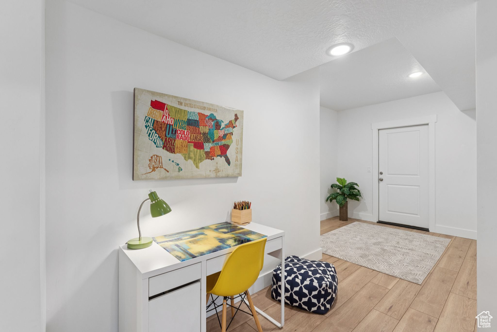 Office area with wood finished floors and recessed lighting