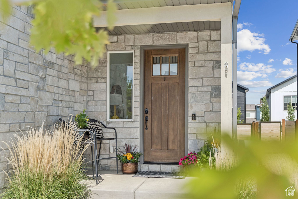 Doorway to property with stone siding