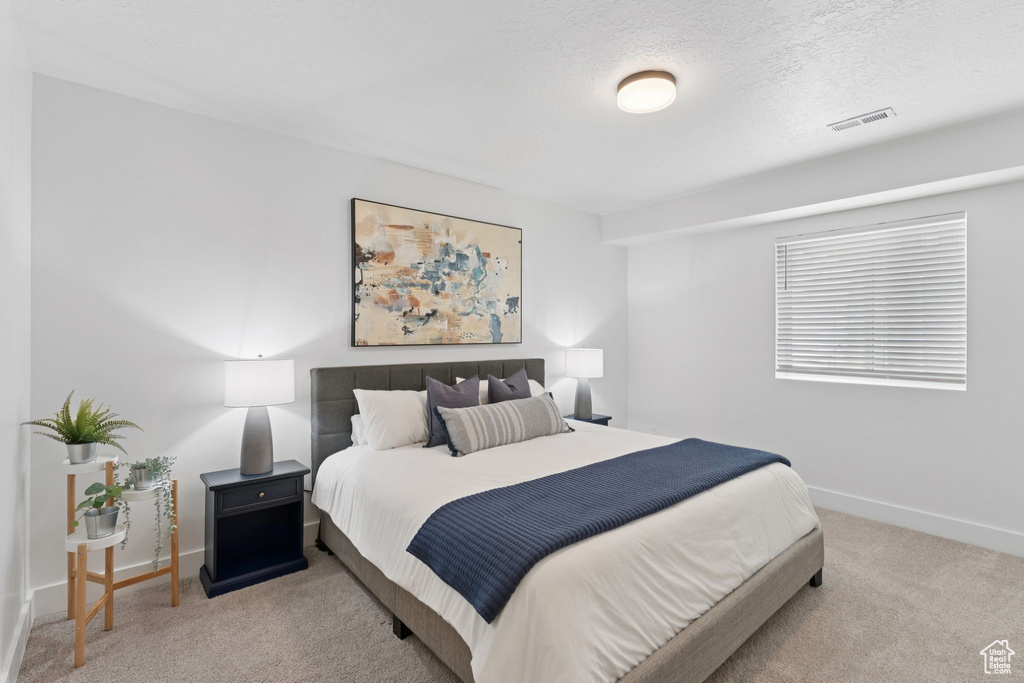 Carpeted bedroom featuring baseboards