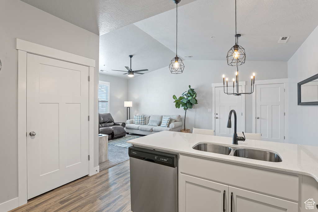 Kitchen with dishwasher, light wood-type flooring, white cabinets, ceiling fan, and hanging light fixtures