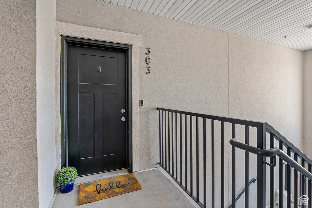 Doorway to property featuring stucco siding