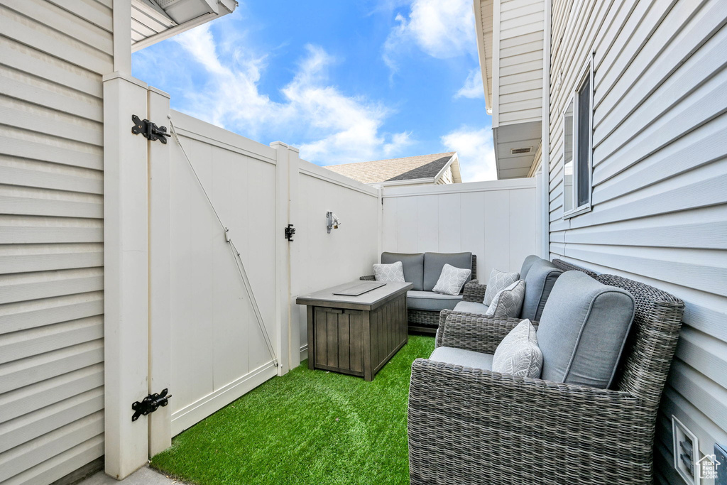 View of patio with a gate and an outdoor hangout area