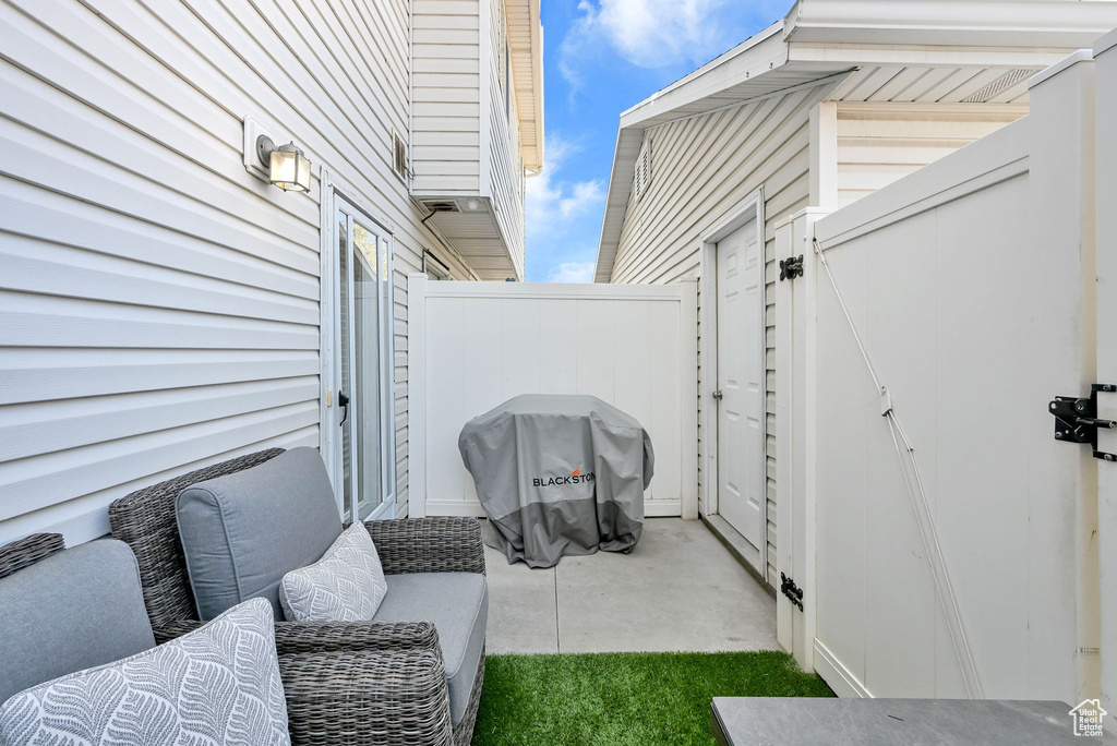 View of patio with a grill