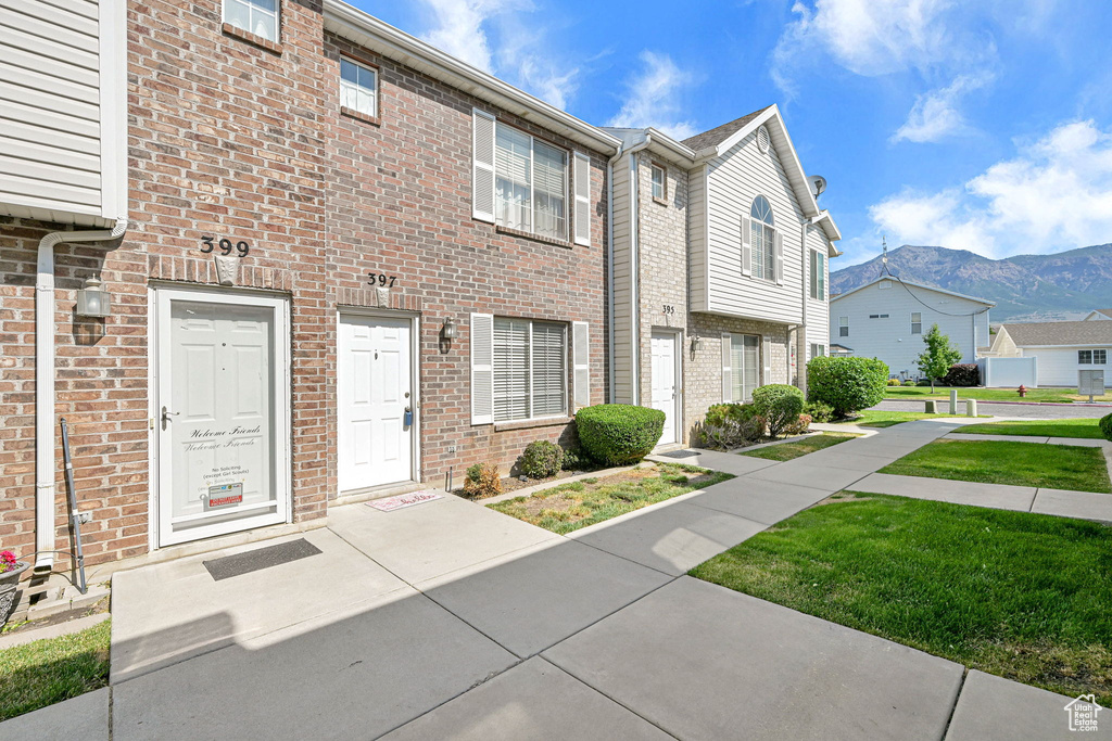 Townhome / multi-family property featuring a mountain view, brick siding, and a residential view
