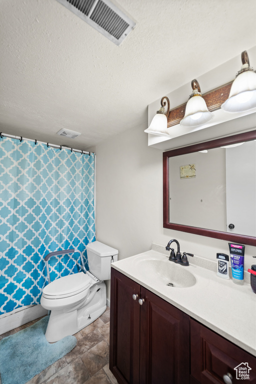 Full bath featuring vanity, a textured ceiling, and a shower with curtain