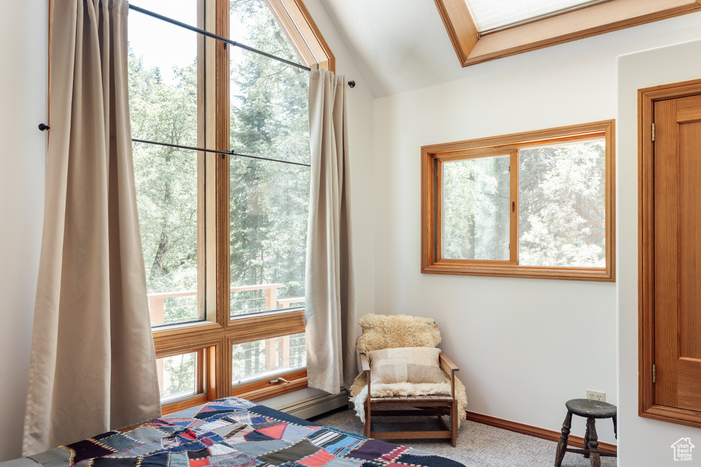 Carpeted bedroom featuring vaulted ceiling and baseboards