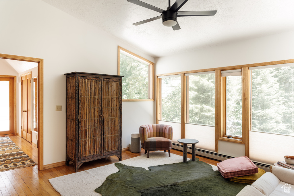 Bedroom with light wood-style flooring, a ceiling fan, and lofted ceiling