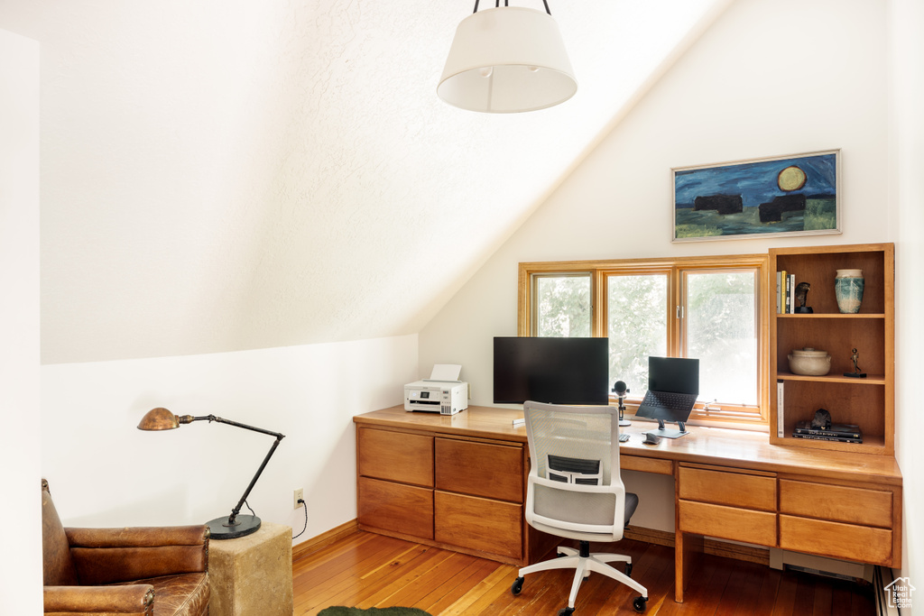 Home office featuring lofted ceiling and light wood-type flooring