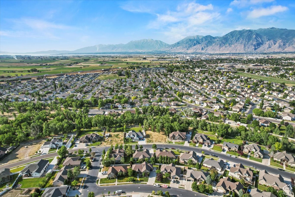 Aerial overview of property's location with a mountain backdrop and nearby suburban area