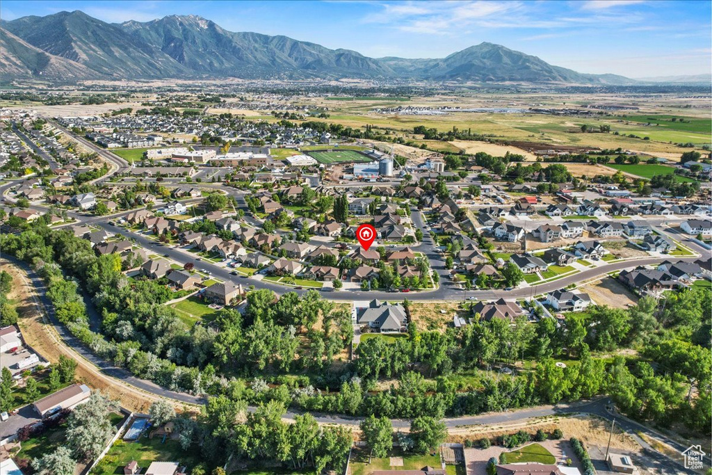 Aerial overview of property's location featuring a mountainous background