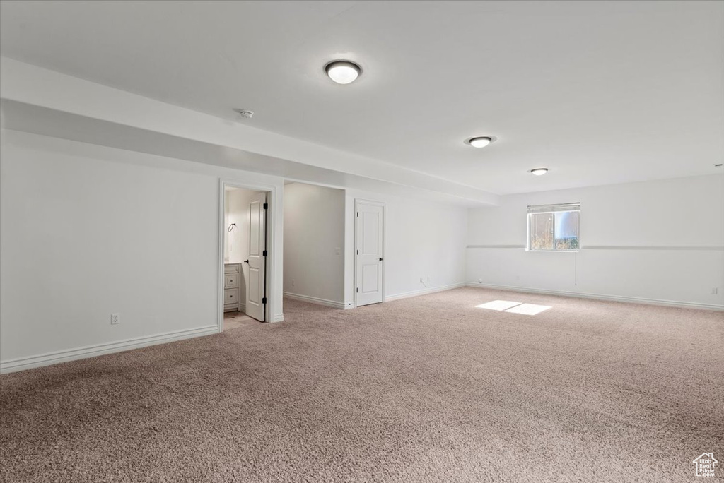 Spare room with light colored carpet and baseboards
