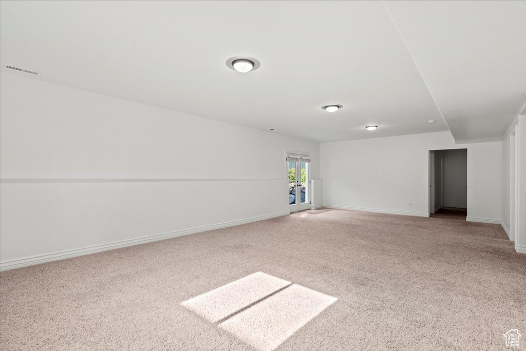 Carpeted empty room featuring baseboards