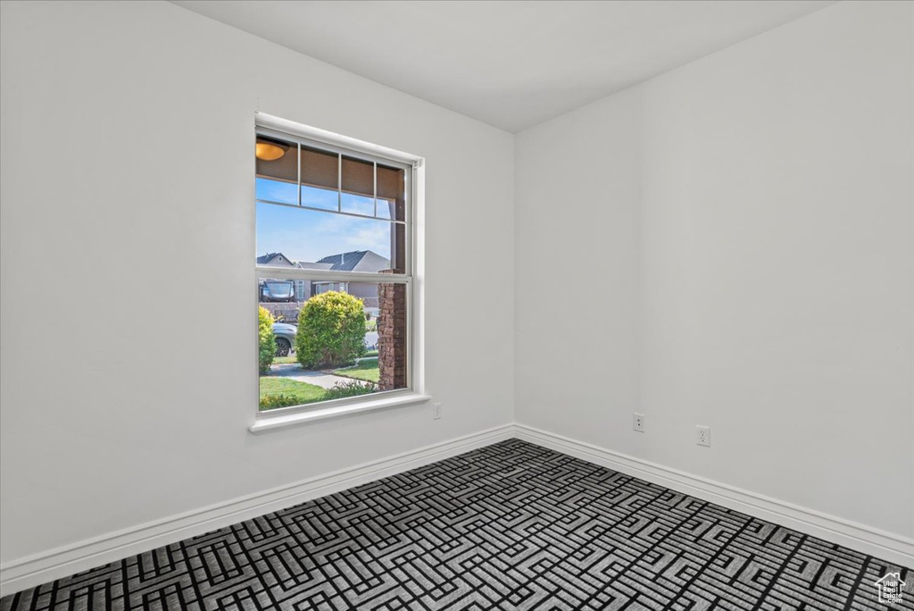 Unfurnished room featuring baseboards