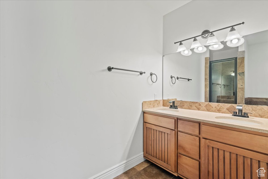 Bathroom with a stall shower and double vanity