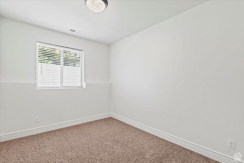 Unfurnished room with carpet flooring and baseboards