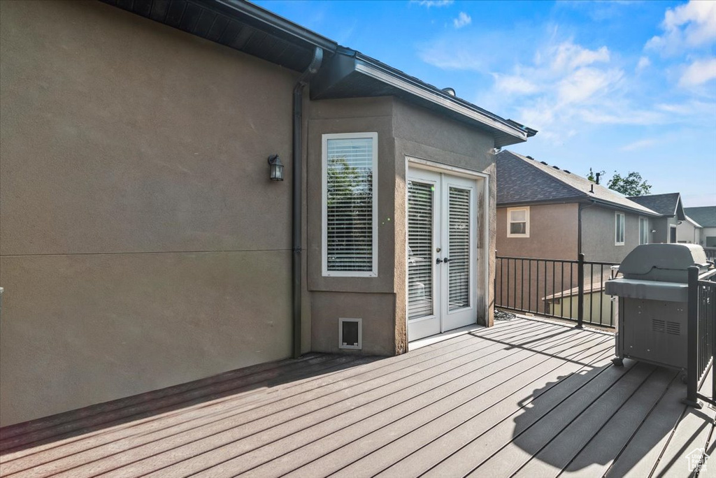 Wooden terrace with french doors and area for grilling