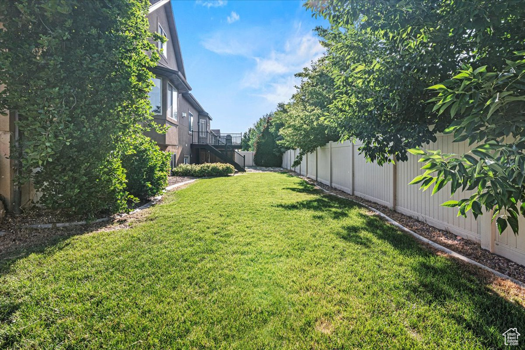 Fenced backyard featuring stairs