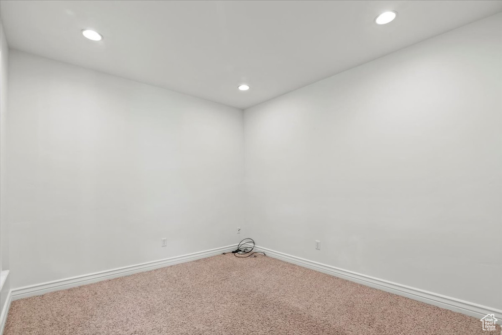 Empty room with carpet floors and recessed lighting