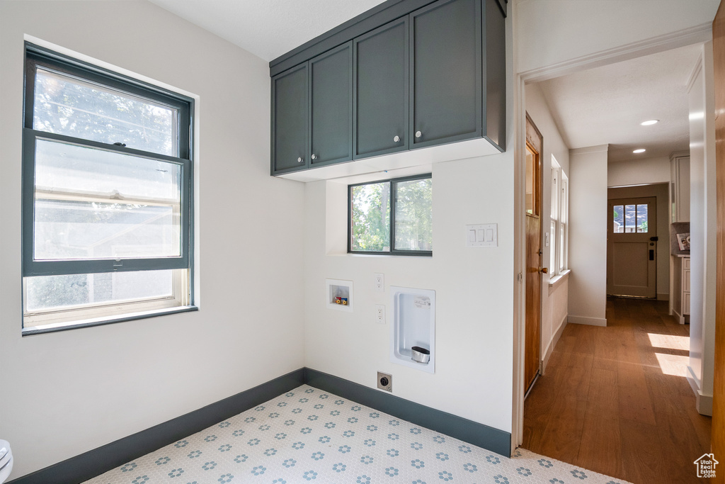 Laundry area featuring hookup for a washing machine, hookup for an electric dryer, cabinet space, recessed lighting, and wood finished floors