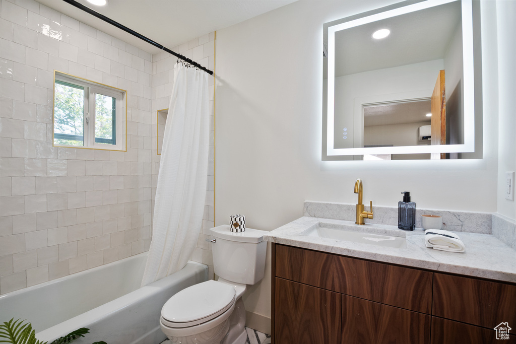 Bathroom with vanity and shower / tub combo