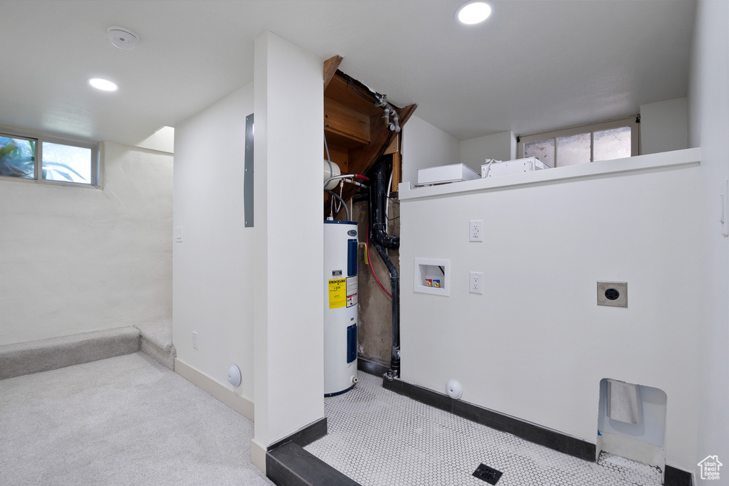 Below grade area featuring water heater, carpet, and recessed lighting