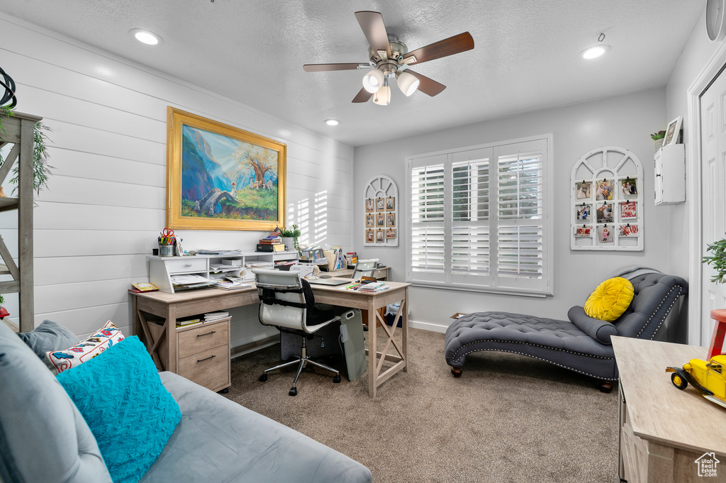 Carpeted home office featuring a ceiling fan, recessed lighting, and a textured ceiling