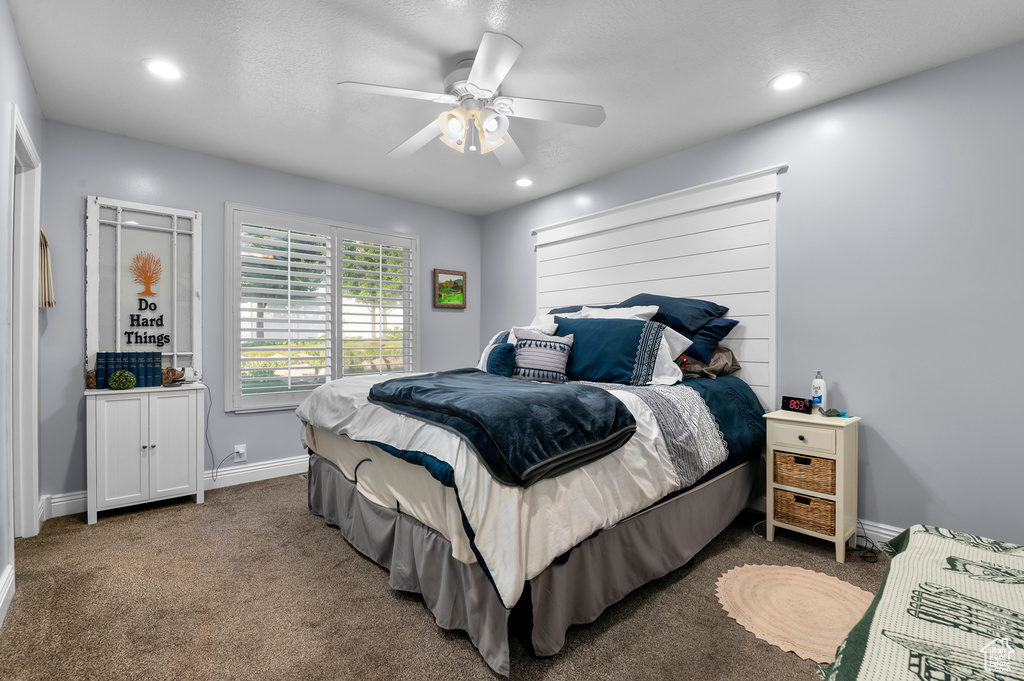 Carpeted bedroom featuring ceiling fan and recessed lighting