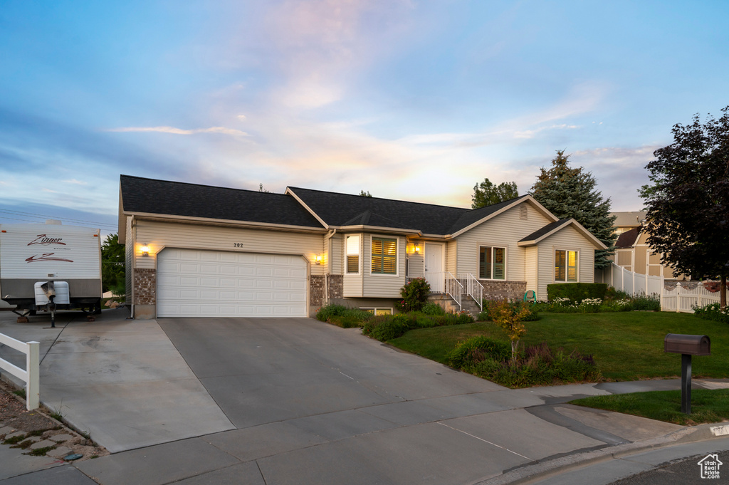 Single story home featuring a garage and concrete driveway