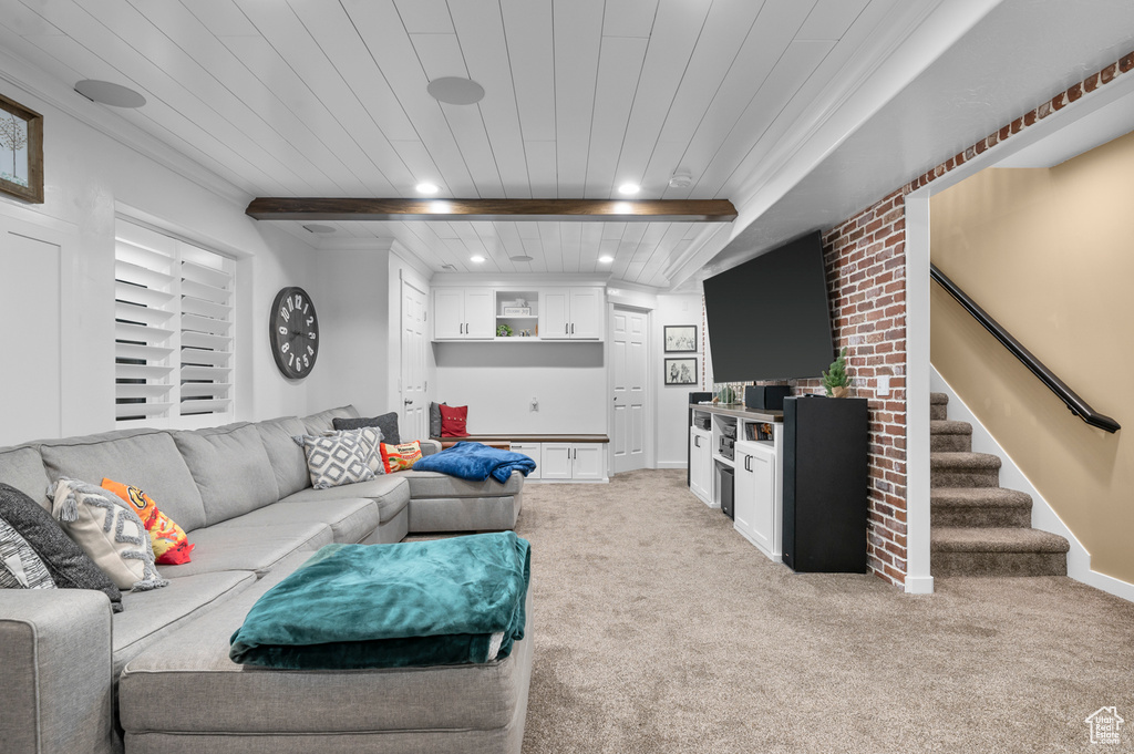 Living room with a wooden ceiling with exposed beams, recessed lighting, light colored carpet, and stairway
