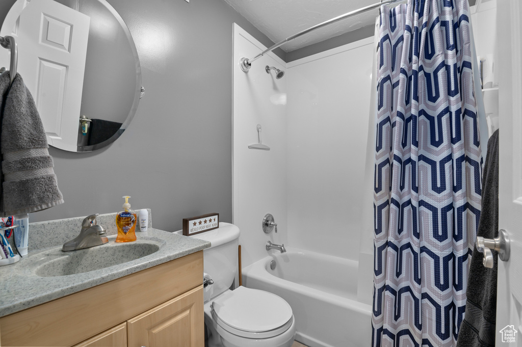 Full bath featuring shower / bath combination with curtain and vanity